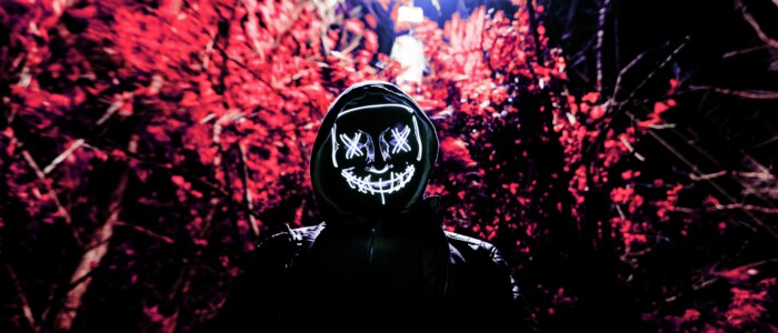 creepy_gangster_in_front_of_tree_in_the_dark